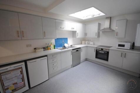 Bright, modern kitchen with abundant white cabi...