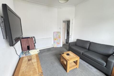 Bright, neutrally decorated living room with a ...