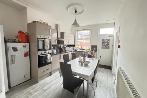 Bright, modern fitted kitchen with dining table...