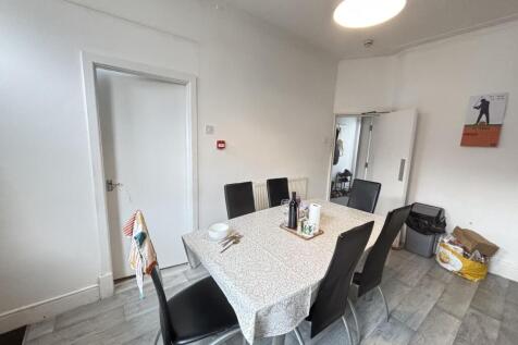 Bright, neutral communal dining or study area w...