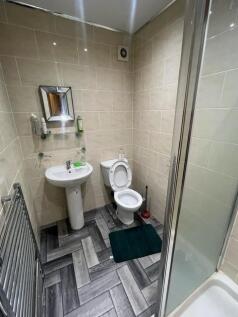 A modern, clean bathroom featuring a toilet, a ...