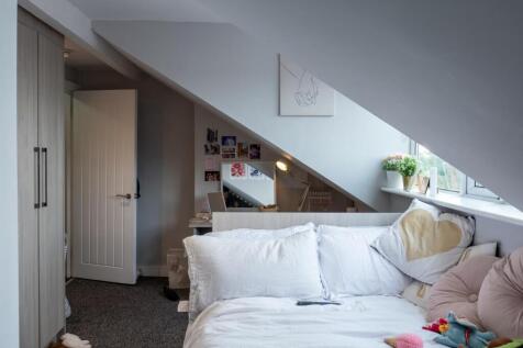 A bright and welcoming living room with a comfo...