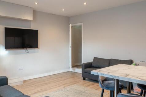 A bright and modern living room featuring comfo...