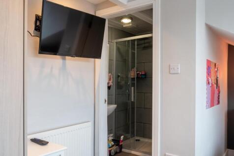 A modern bathroom featuring a glass shower encl...