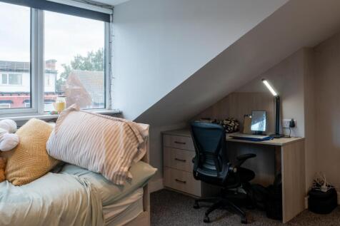 A cozy bedroom with a comfortable bed, a study ...