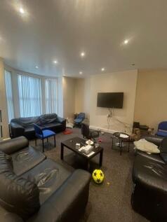 A spacious and modern living room featuring com...