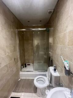 A modern bathroom featuring a spacious shower e...