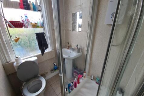 A clean and functional bathroom with a toilet, ...