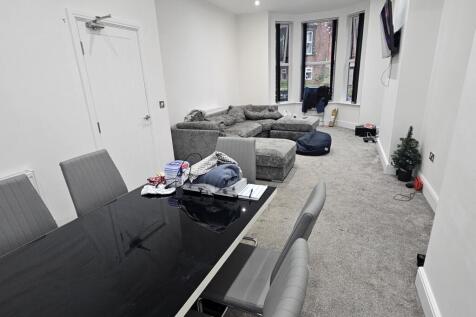 A spacious and modern living room featuring amp...