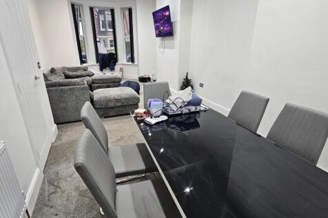 A modern, well-lit living room featuring comfor...