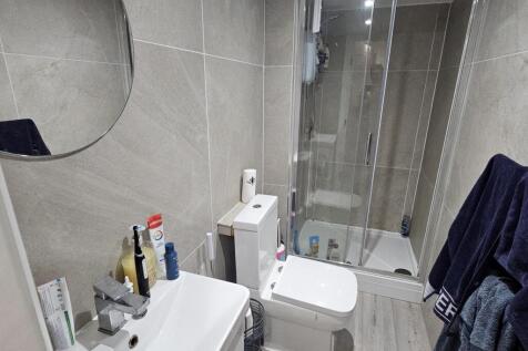 A clean and modern bathroom featuring a toilet,...