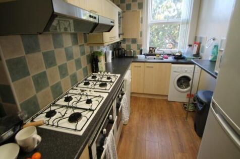 A functional and well-lit kitchen with a gas st...