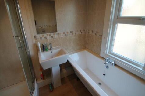 Bright and clean bathroom featuring a large bat...