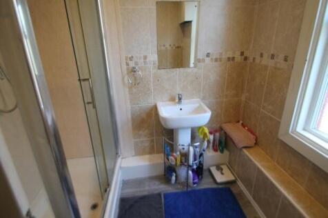 A clean and bright bathroom featuring a shower,...