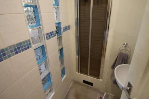 A modern, clean bathroom featuring a large bath...