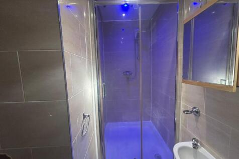 Modern and clean bathroom with a shower enclosu...