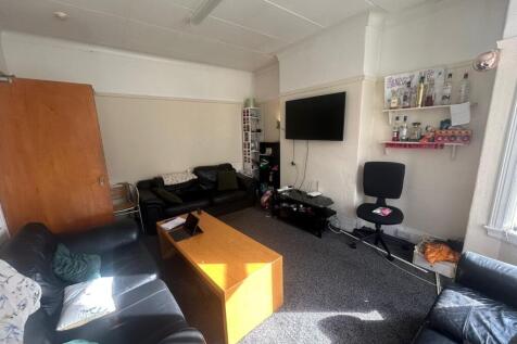 A spacious and inviting living room featuring m...