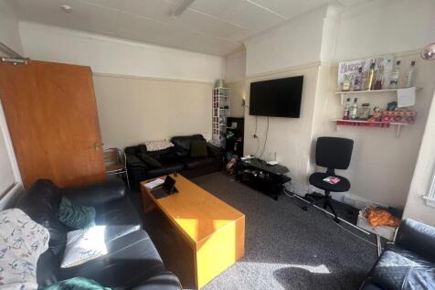 A spacious and modern living room featuring com...