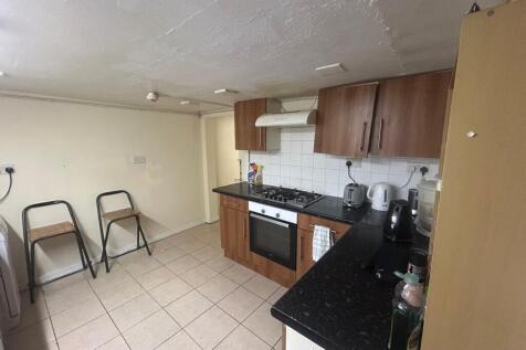 A well-maintained kitchen with modern wooden ca...