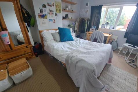 A bright and inviting master bedroom featuring ...