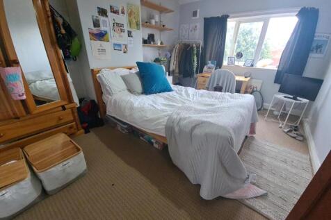 Bright and welcoming bedroom featuring a spacio...