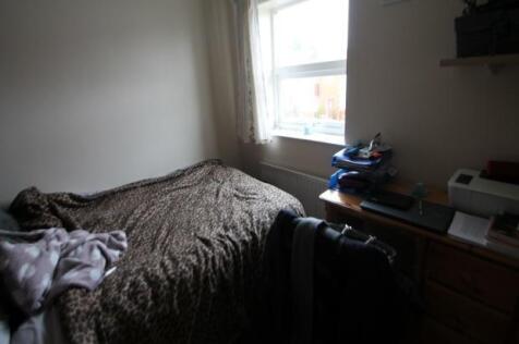 A cozy bedroom with a bed placed against the wa...