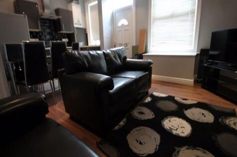 A cozy living room featuring comfortable black ...