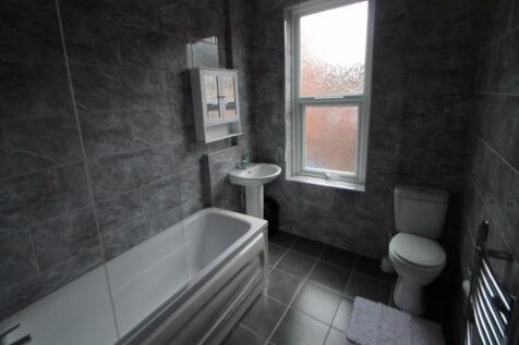 A modern bathroom suite featuring a full bathtu...
