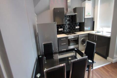 Modern kitchen featuring sleek black and grey c...