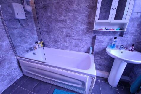 A modern bathroom featuring a clean white batht...