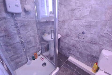 Modern bathroom with a sleek corner shower unit...