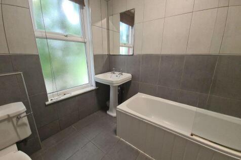 A modern bathroom suite with a large bathtub, w...