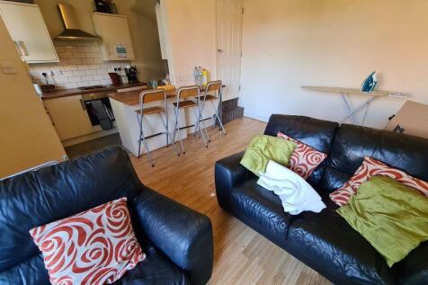 A cozy and well-kept living room featuring comf...