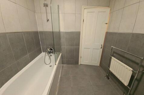 Spacious bathroom featuring a modern bathtub wi...