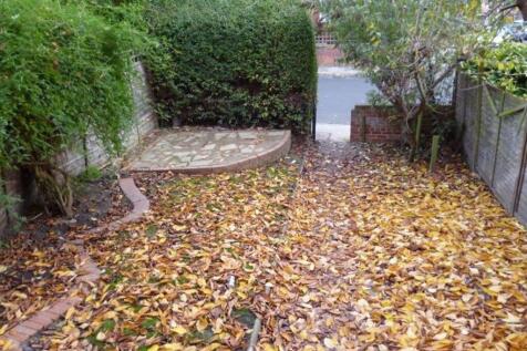 A charming private garden space with mature hed...