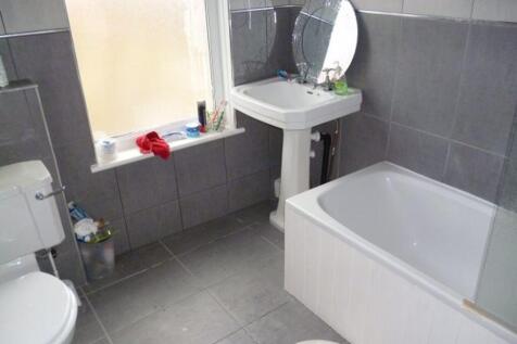 A modern bathroom suite featuring a clean white...