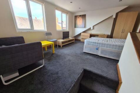 Spacious and well-lit master bedroom featuring ...