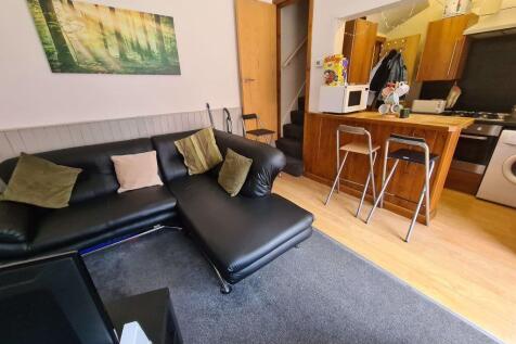 Bright and modern living area featuring a comfo...