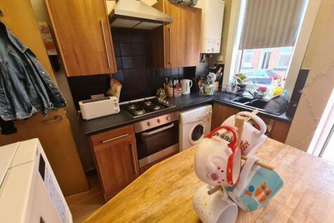 A compact and functional kitchen featuring wood...
