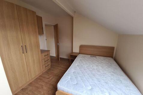 A bright and tidy bedroom featuring a double be...