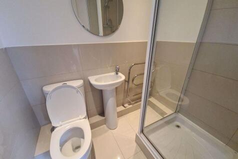 A clean, modern bathroom featuring a toilet, a ...
