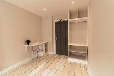 Bright, freshly decorated bedroom with pale woo...