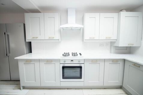 Bright modern kitchen with white shaker-style c...