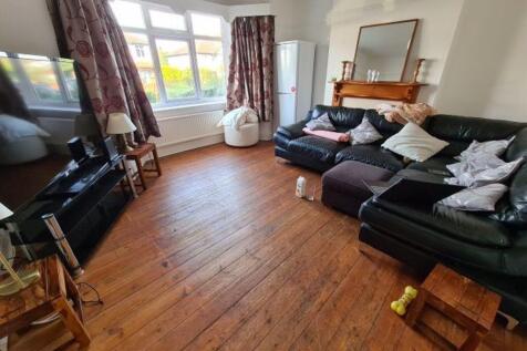 A bright, spacious living room featuring large ...