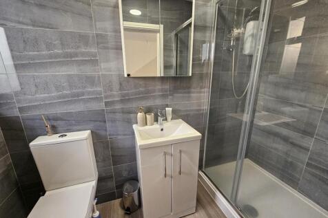 Modern bathroom featuring a sleek glass shower ...
