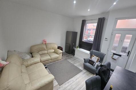 Bright and inviting living room featuring comfo...