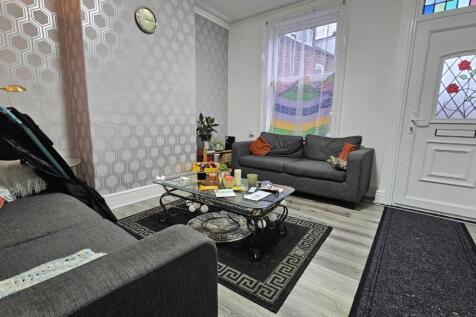 Modern and well-lit living room featuring comfo...