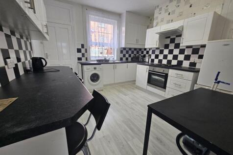 Bright and modern kitchen with ample natural li...