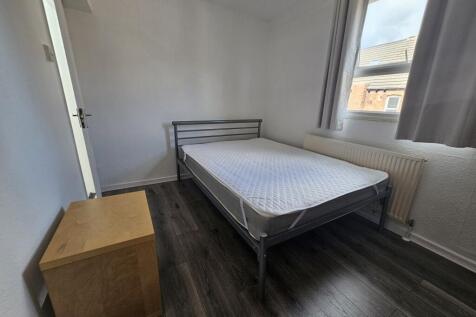A neatly presented single bedroom with minimal ...