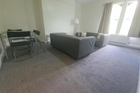 A bright and welcoming living room featuring a ...
